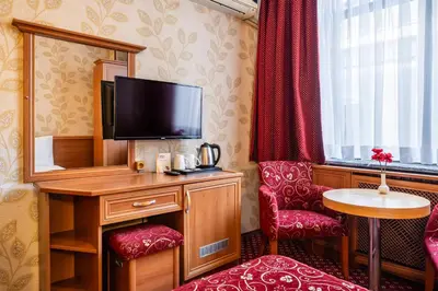 a hotel room with a tv and a mirror at Hotel Bristol in Istanbul