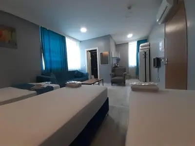 a hotel room with two beds and a living room at 216 Turkuaz Suit in Istanbul