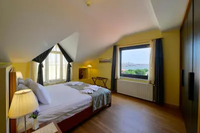 a bedroom with a large bed and a large window at Agora Life Hotel - Special Class in Istanbul