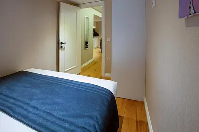 a bedroom with a bed with a blue blanket at Moss Suites Hotel in Istanbul
