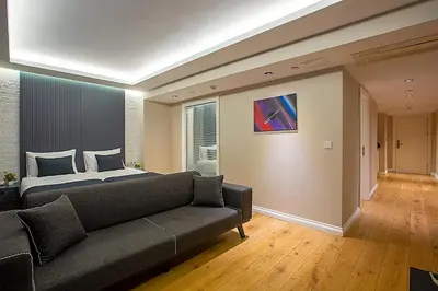 a bedroom with a bed and a couch at Moss Suites Hotel in Istanbul
