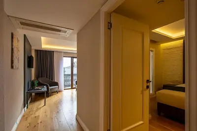 a room with a bed and a room with a hallway at Moss Suites Hotel in Istanbul