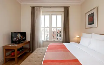 a bedroom with a large bed and a window at Tomtom Suites in Istanbul