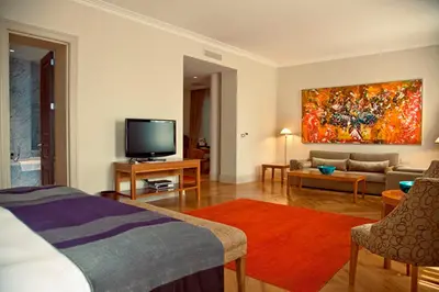 a living room with a bed and a tv and a couch at Tomtom Suites in Istanbul