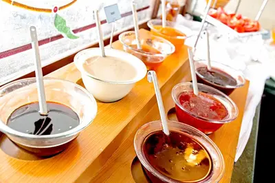 a wooden table topped with bowls of different types of food at Apart Hotel Hippodrome in Istanbul