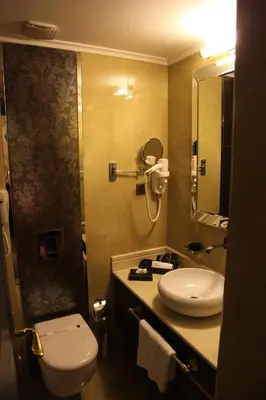a bathroom with a sink and a toilet and a mirror at Mirilayon Hotel - Old Town in Istanbul