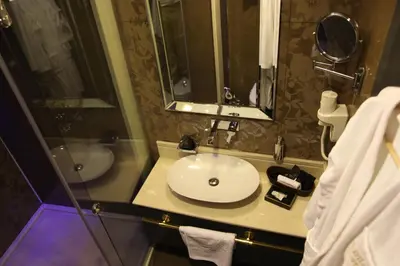 a bathroom with a white sink and a mirror at Mirilayon Hotel - Old Town in Istanbul
