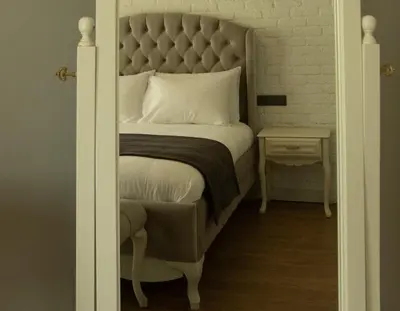 a bedroom with a large bed with a padded headboard at Louis Rooms in Istanbul