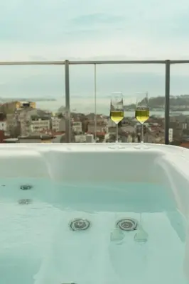 two glasses of wine sitting in a bath tub at Louis Rooms in Istanbul