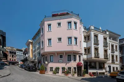 a pink building on the side of a street at Osmanhan Hotel in Istanbul