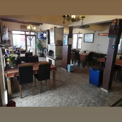 a dining room and kitchen with tables and chairs at Zirve Dağ Evi in Kocaeli