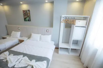a small room with two beds and a crib at Express İnci Hotel in Istanbul