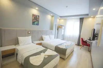 a hotel room with two beds and a television at Express İnci Hotel in Istanbul