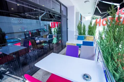 a restaurant with tables and chairs in front of a window at Express İnci Hotel in Istanbul