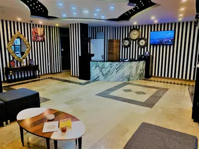 a lobby with a table and a clock on the wall at Express İnci Hotel in Istanbul