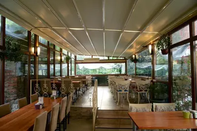 a restaurant with tables and chairs and windows at Tashkonak Studio Suites in Istanbul