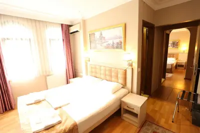 a hotel room with a bed and a table in it at Tashkonak Studio Suites in Istanbul
