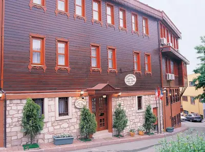 a large wooden building on the corner of a street at Tashkonak Studio Suites in Istanbul