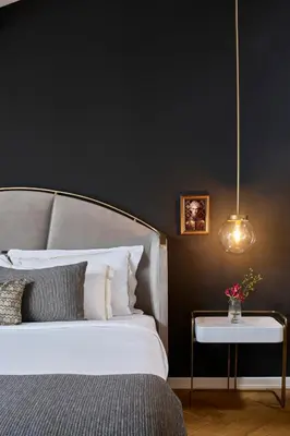 a bedroom with a white bed and a table with flowers at Mr Cas Hotels Taksim - Special Category in Istanbul