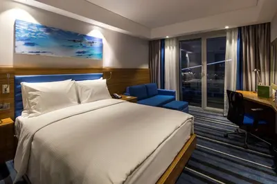 a hotel room with a bed and a desk and a computer at Hampton by Hilton Istanbul Kurtkoy in Istanbul