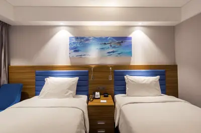 a hotel room with two beds and a painting on the wall at Hampton by Hilton Istanbul Kurtkoy in Istanbul