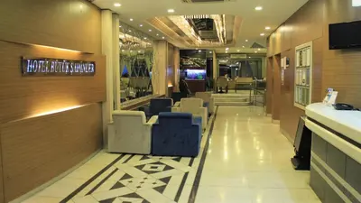 a lobby of a restaurant with chairs and a bar at Hotel Buyuk Sahinler in Istanbul