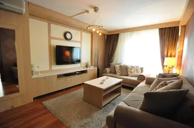 a living room with a couch and a tv at Hotel Buyuk Sahinler in Istanbul