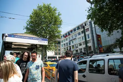 a group of people standing on a busy city street at Yuksel Hotel in Istanbul