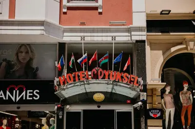 a sign for a store with flags in front of it at Yuksel Hotel in Istanbul