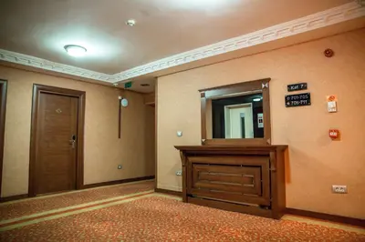 a hallway with a door and a mirror on a wall at Yuksel Hotel in Istanbul