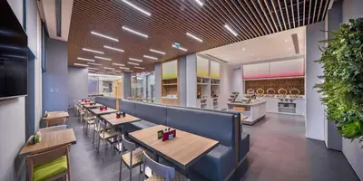 a dining room with tables and chairs in a restaurant at Hampton by Hilton Istanbul Zeytinburnu in Istanbul