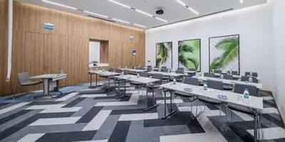 a conference room with tables and chairs in it at Hampton by Hilton Istanbul Zeytinburnu in Istanbul