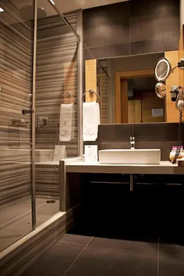 a bathroom with a sink and a shower at Point Hotel Barbaros in Istanbul