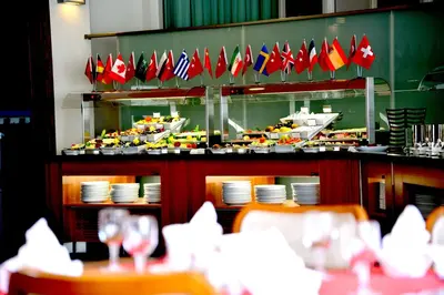 a restaurant with a bunch of flags on a counter at Hotel Hegsagone Marine Asia in Gebze