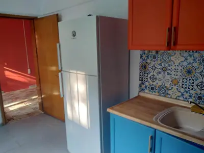 a kitchen with a white refrigerator and a sink at Apartament Ada in Buyukada