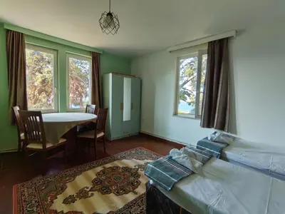 a room with a couch and a table and windows at Apartament Ada in Buyukada