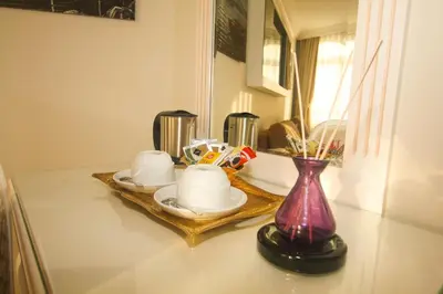 a table with two cups and a vase on it at Venue Hotel Istanbul Old City in Istanbul
