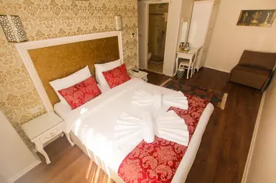 a bedroom with a large white bed with red pillows at Venue Hotel Istanbul Old City in Istanbul