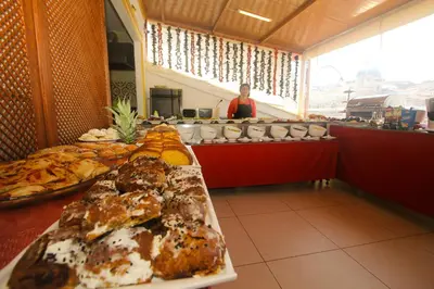 a woman standing behind a buffet line with food at Venue Hotel Istanbul Old City in Istanbul