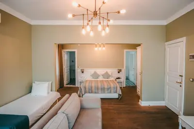 a living room with a couch and a bed at Rodosto Hotel in Tekirdag