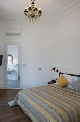 a bedroom with a bed and a chandelier at Rodosto Hotel in Tekirdag