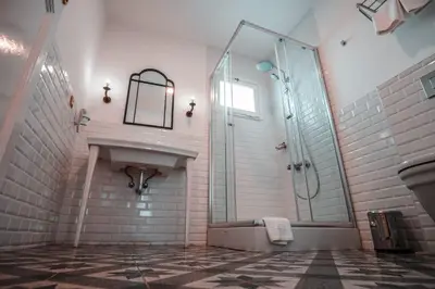 a bathroom with a glass shower and a sink at Rodosto Hotel in Tekirdag