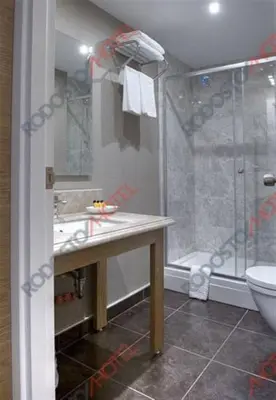a bathroom with a shower and a sink and a toilet at Rodosto Hotel in Tekirdag