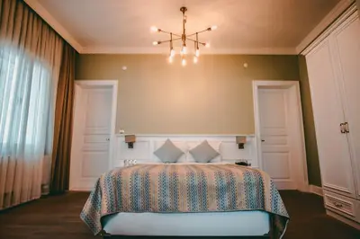 a bedroom with a bed and a chandelier at Rodosto Hotel in Tekirdag