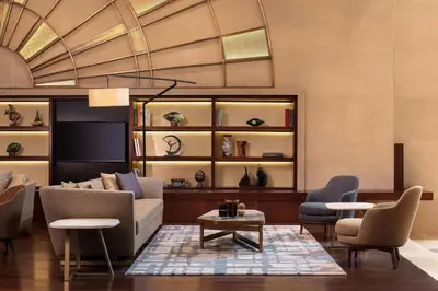 a living room with a couch and chairs and a table at Sheraton Istanbul Levent in Istanbul