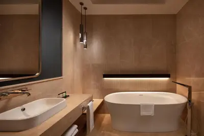 a bathroom with a large tub and a sink at Sheraton Istanbul Levent in Istanbul
