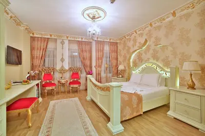 a bedroom with a bed and a desk and chairs at White House Hotel Istanbul in Istanbul