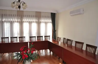 a large room with a long table and chairs at Turquhouse Hotel in Istanbul