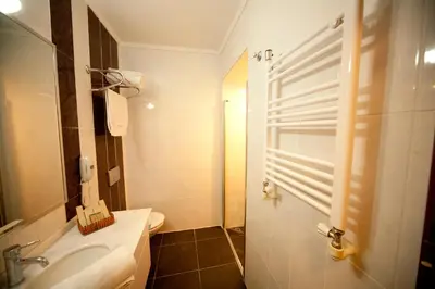 a bathroom with a sink and a toilet and a mirror at Turquhouse Hotel in Istanbul