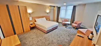 a hotel room with a bed and a television at Silivri Park Hotel in Silivri
